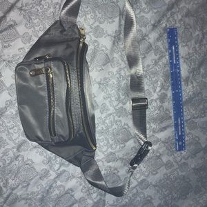 Gray fanny pack aka bum bag. Yellow gold color accents. Used once